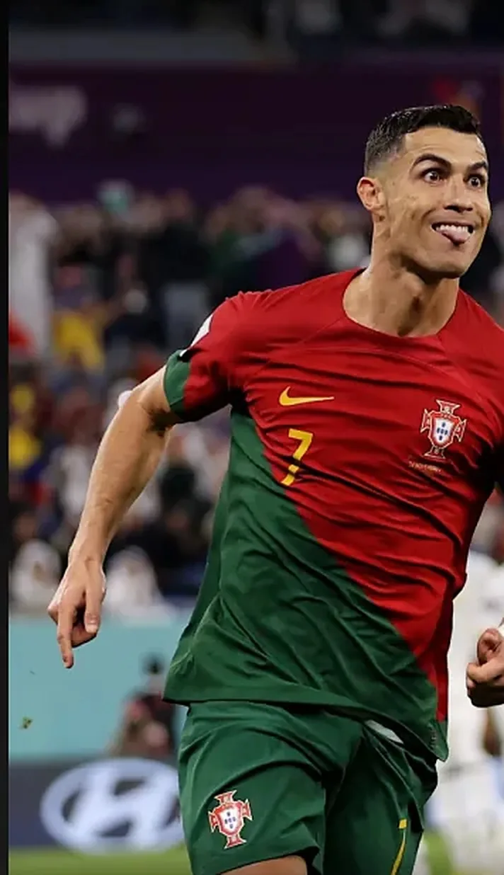 A footballer running onto the pitch