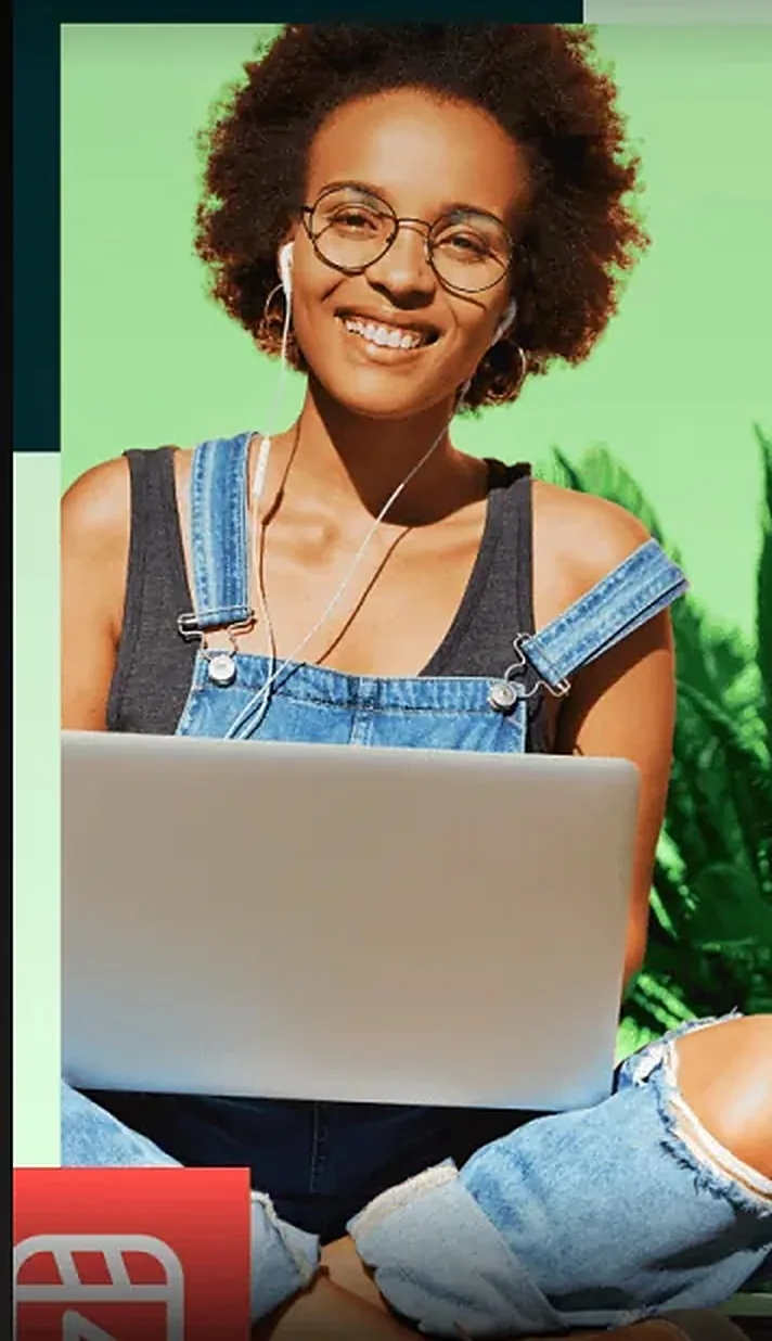 A student smiling at her laptop